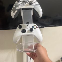 Two Xbox Controllers With A Desk Stand 