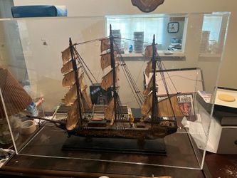 a decorative wooden three-masted sailing ship model