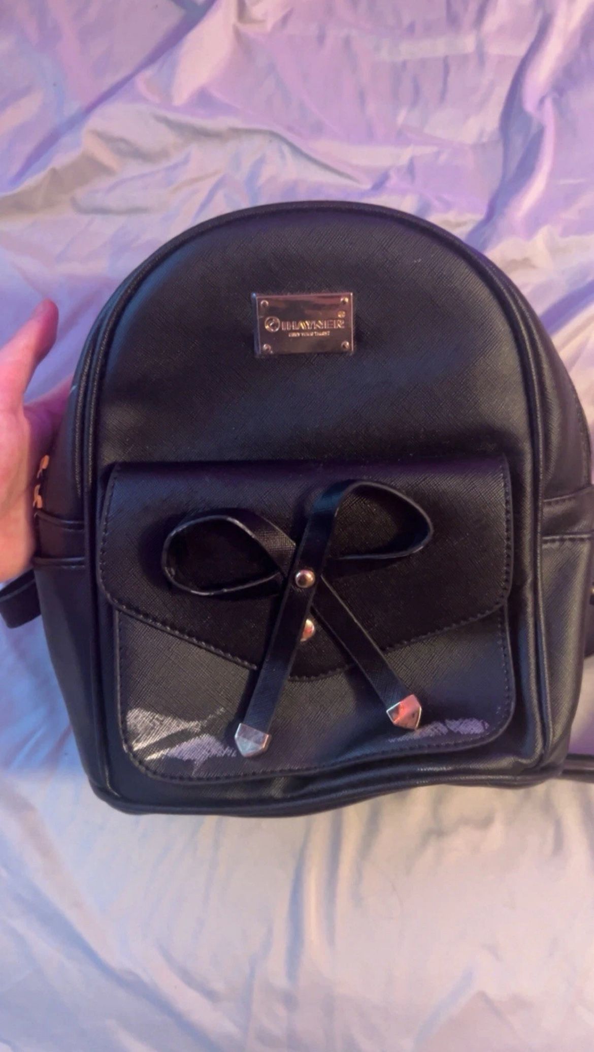 Black Mini Bookbag With Some Scratches Two Compartments For Storage