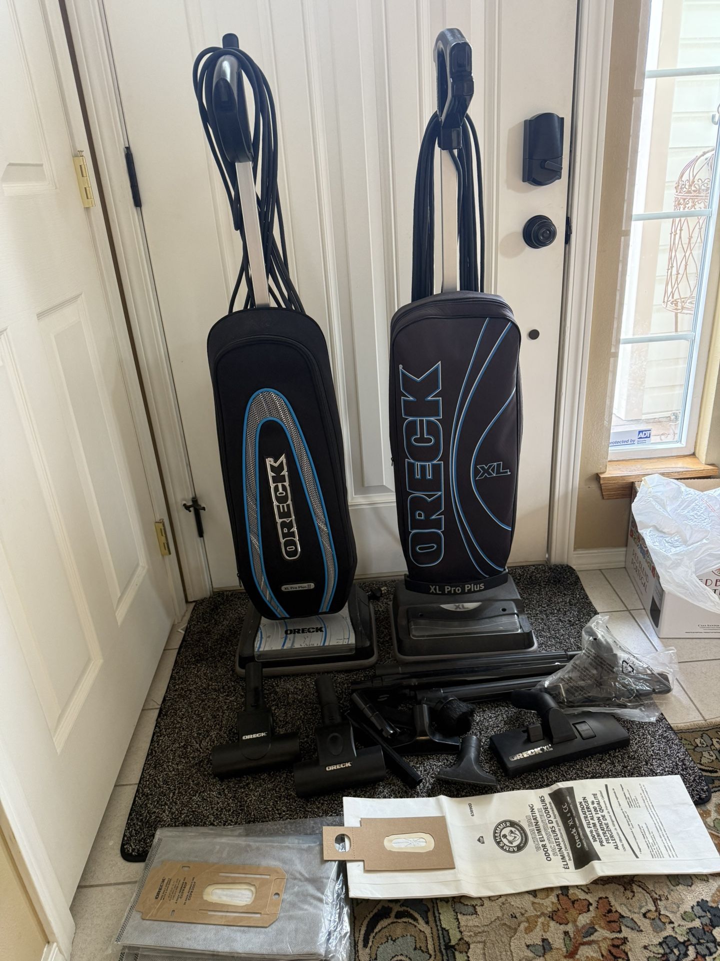 Two Oreo Upright Vacuum Cleaners With Attachments And Bags.
