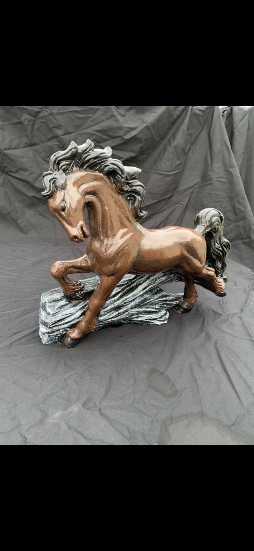 Horse, jumping over a log statue