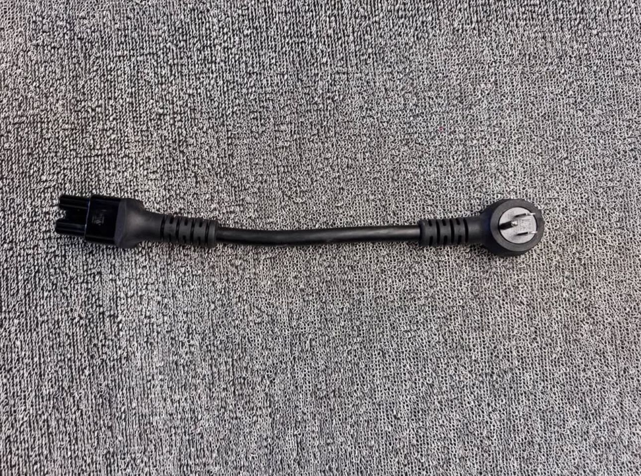 Rivian OEM NEMA space 5–15 adapter for a portable charger