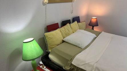 Queen  Bed  with attached nightstand and lamps