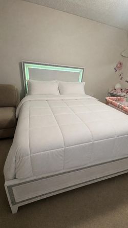 Bedroom set: bed with two nightstands and a dresser with a mirror.