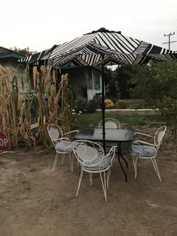 Patio set 5 PCs (metal table with glass and 4 metal chairs with cushions and not including umbrella