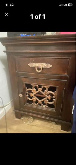 Dark Wood Nightstand with Ornate Cabinet Door