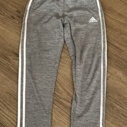 Adidas Kids Gray Joggers with White Stripes Size 8. Stylish gray joggers for kids. Features iconic white stripes. Perfect for active wear. Back bottom