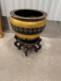 Stylish Gold and black pot with wooden stand.  14” around , 19” high  $70