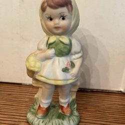 Mid century, bisque porcelain girl holding a basket Made in Japan