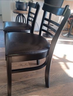 2 black wooden chairs