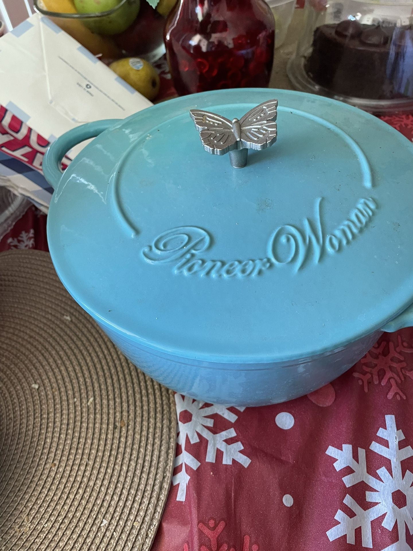 Dutch oven. Made by pioneer women. Color blue. Butterfly on top of pot for handle.