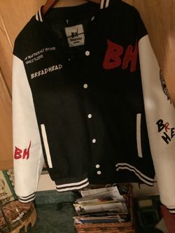 Bread Bully letterman varsity jacket features a black wool body with contrasting white leather sleeves and red embroidered text.  Beautifully done sti
