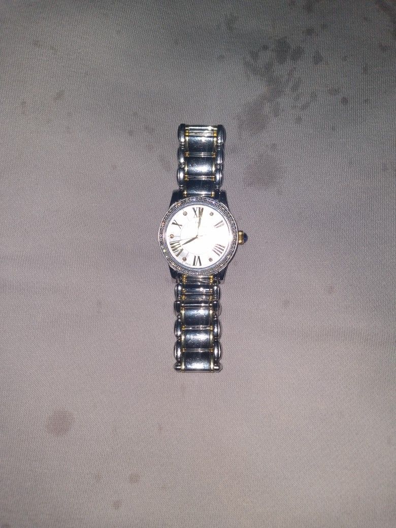 Stunning And Well Kept Ladies Stainless Steel 18k Gold Plated Watch. Diamonds And A Single Sapphire Finish This Lovely Watch A Must Have.