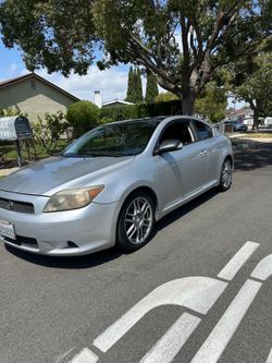 silver Scion tC hatchback coupe.