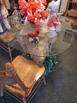 Lion table carved out of one piece of wood, 3 lion faces.\nHeavy one of a kind with a glass top , perfect , very heavy and four chairs at match