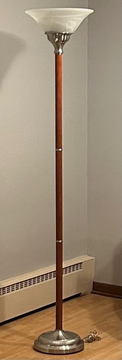 Beautiful torchiere mid-century modern floor lamp features a wood stem and brushed nickel base.