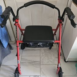 Walker with brakes, four wheels, seat, and storage space, almost new