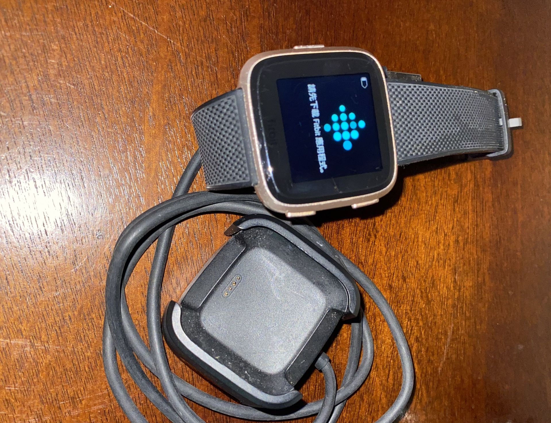 Rose gold Fit Bit Versa and Charger