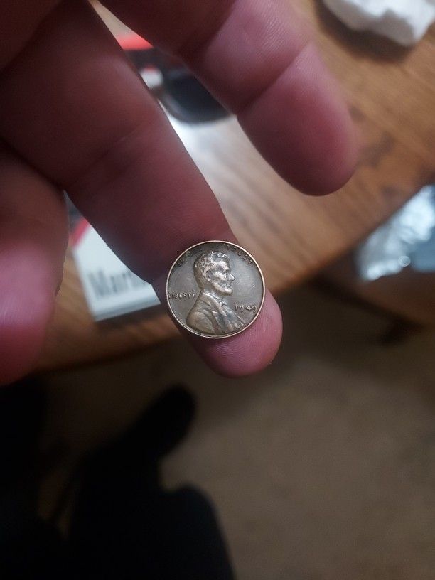1949 wheat penny no mint mark slightly off struck