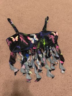Black crop top with vibrant multicolored butterfly and fairy prints. Adjustable thin straps. Playful fringe hem with removable metal charm with chain