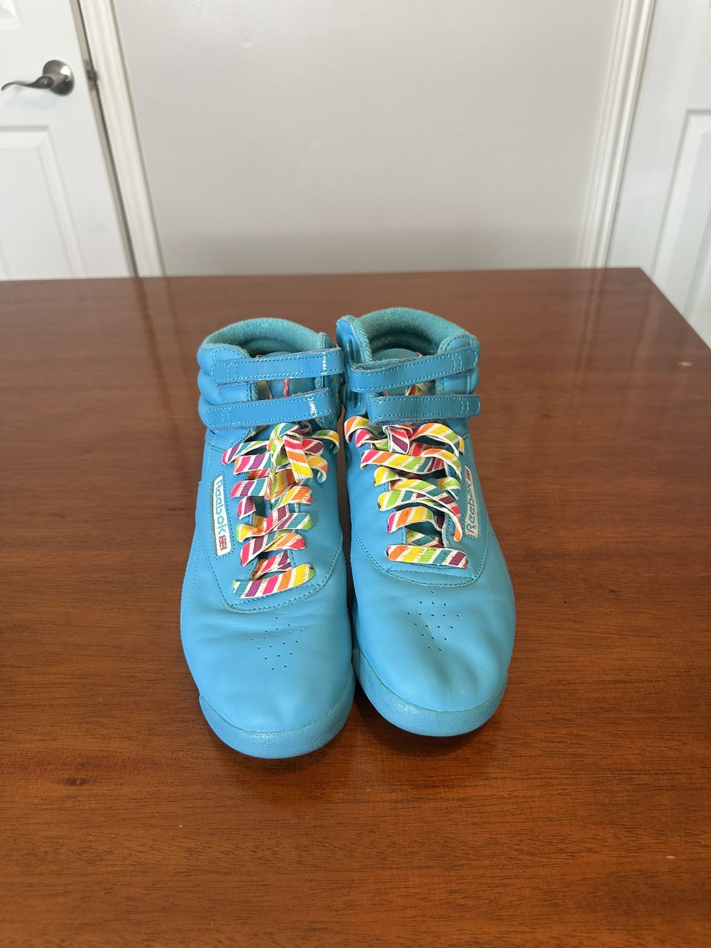 Blue Reebok high top sneakers with rainbow laces