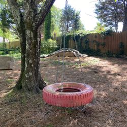 Red Tire Swing With Chains And Swivel.