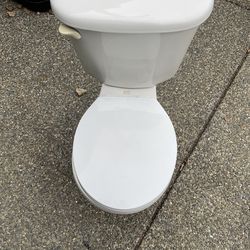 American Standard toilet and metal sink with faucet