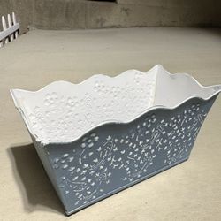 galvanized metal flower pot or planter featuring a embossed floral or paisley pattern.