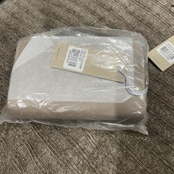 Wristlet wallet with zip-around and magnetic snap closure.