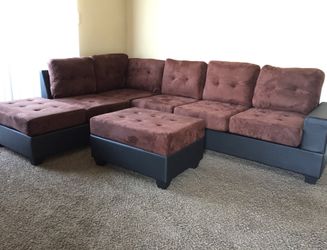 brand new reversible sectional sofa with drop down cup holders, and storage ottoman.