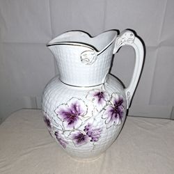 Beautiful white vintage pitcher. Gold color trim with plum and lavender color leaves