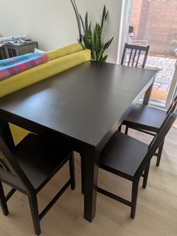 Gently used extending table with 2 leaves and 4 chairs.