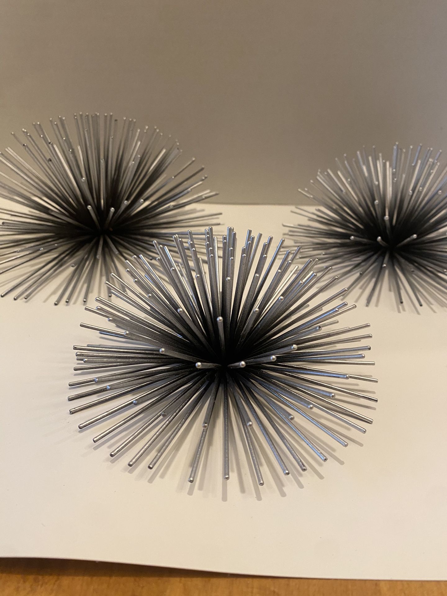 MCM metal Sea Urchin sunburst silver & black wall hangings. Set of three. 7.5 & 6.5 inch & 5.5 inches.