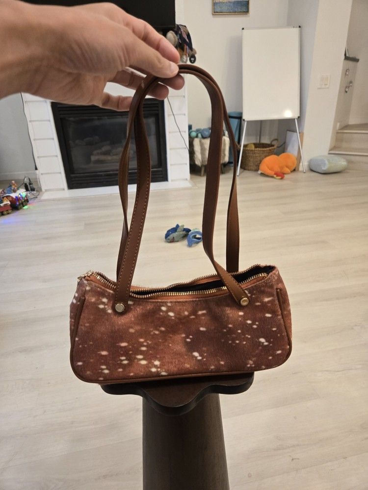 faux pony skin shoulder bag in a deer print