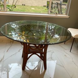 48” round bevelled glass table with Rattan base . 