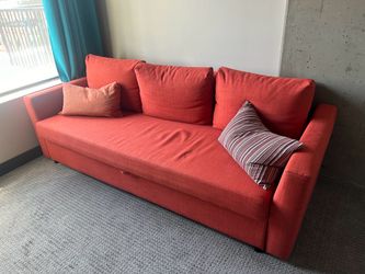 Ikea Friheten fold-out couch (orange) with storage and cushions