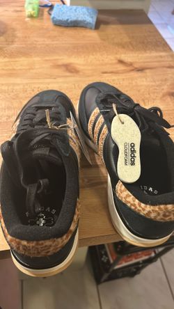 Adidas black with cheetah on the side and back of the sneakers