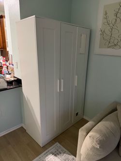 Tall White Storage Cabinet with Doors and Mirror.