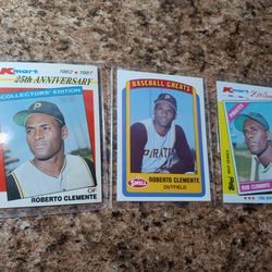 Three Roberto Clemente Baseball Cards.