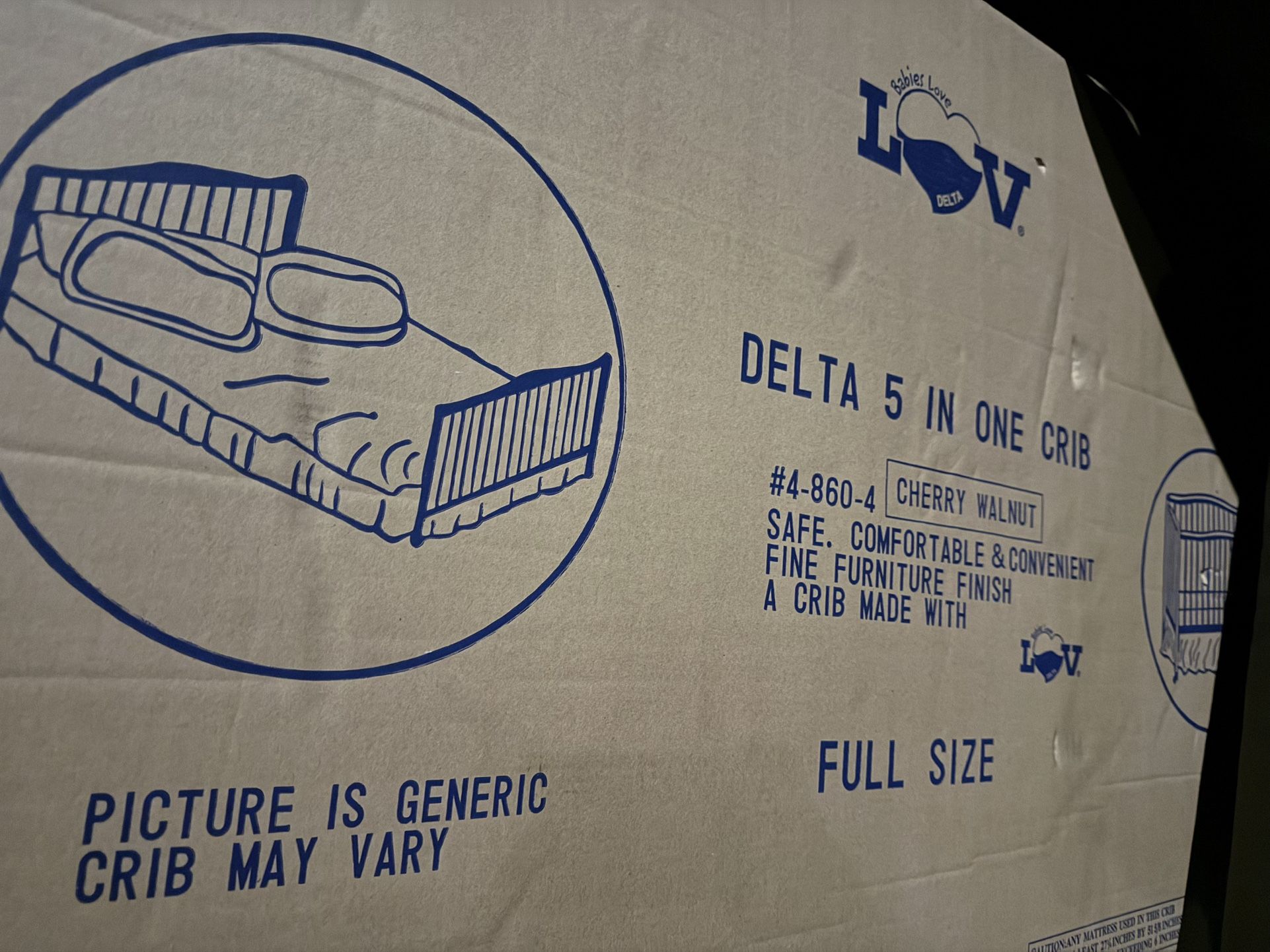 Delta 5-in-One Full-Size Wooden Crib in its original box.