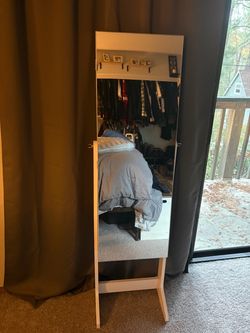 Mirror with jewelry storage