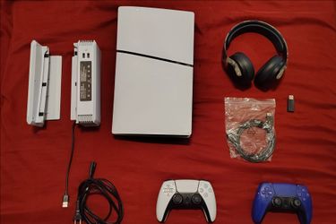 PS5 slim with 2 controllers, headset, and cooling station.