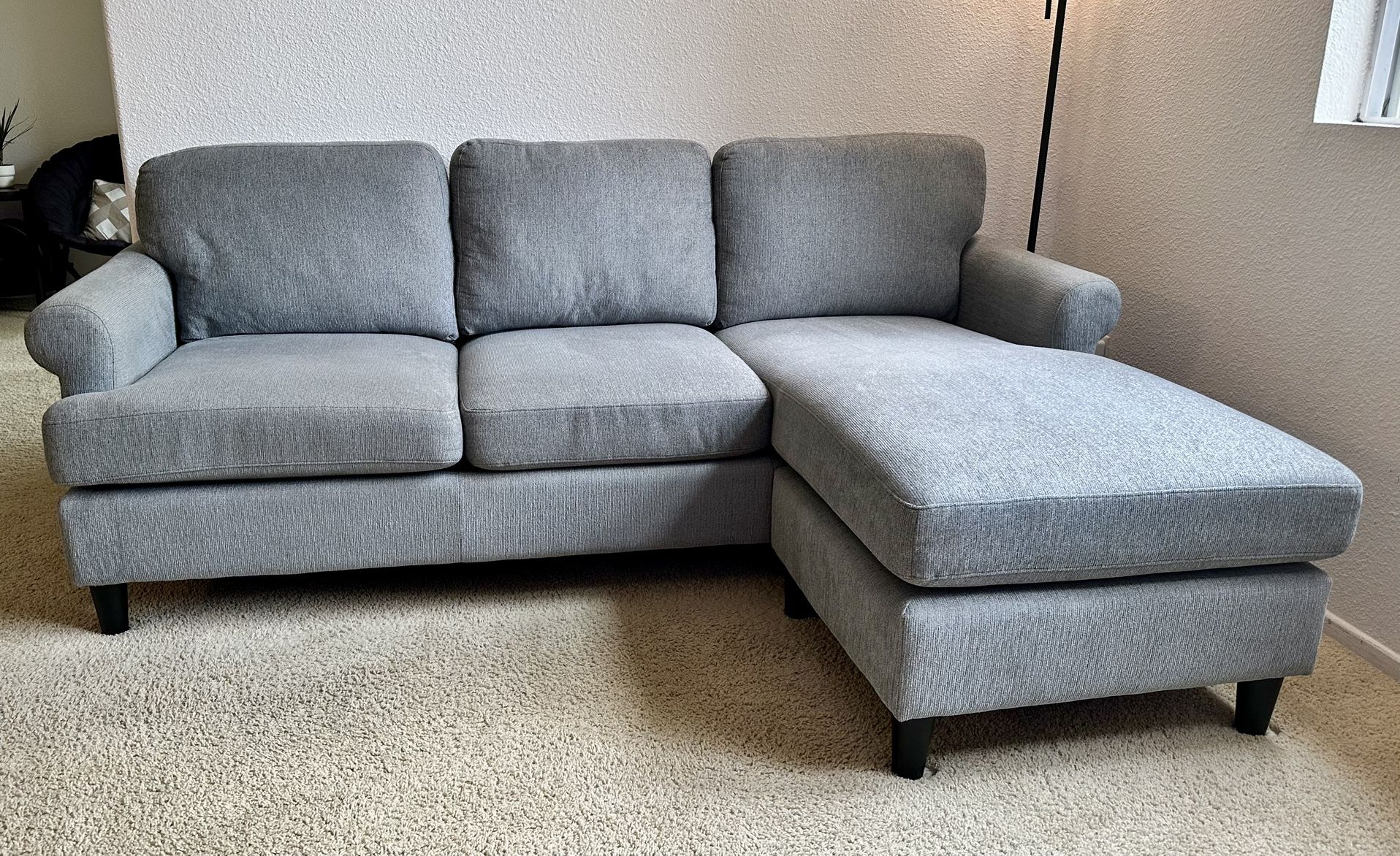 Super comfy greyish blue tLiving Spaces Sofa with Reversible Chaise - less than 1 year old