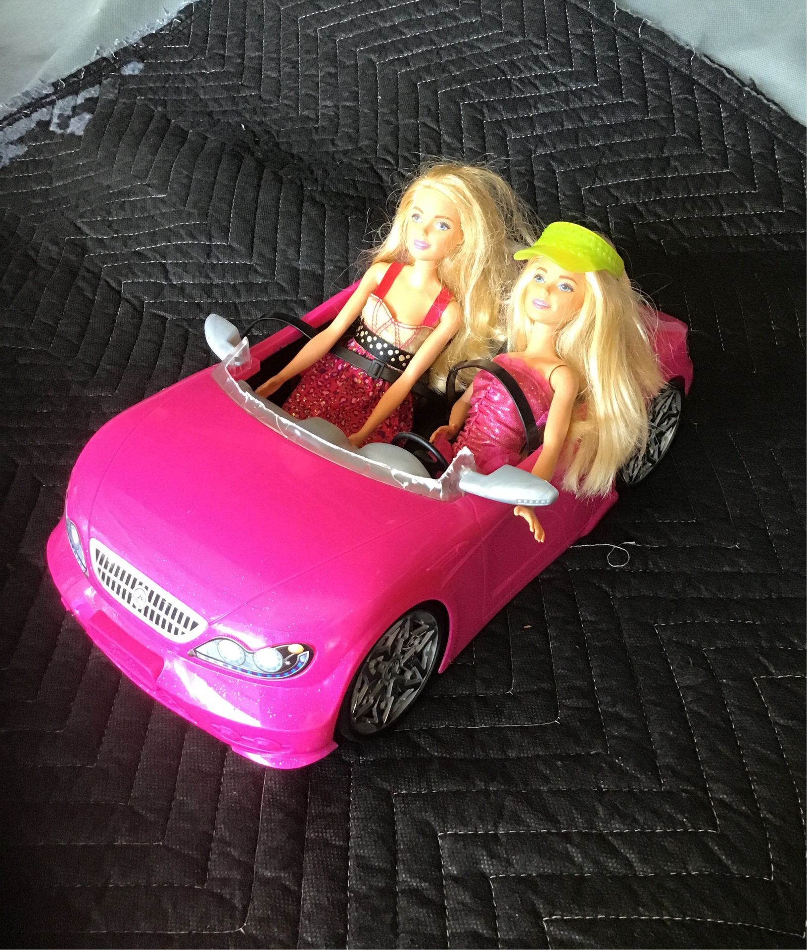 2 barbies with pink convertible