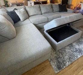 Grey sectional couch with ottoman