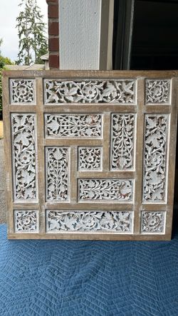 This rustic Indian-inspired hand-carved wooden wall panel
