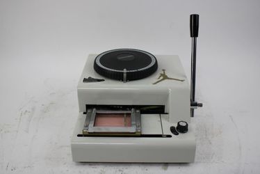 Credit card embossing machine