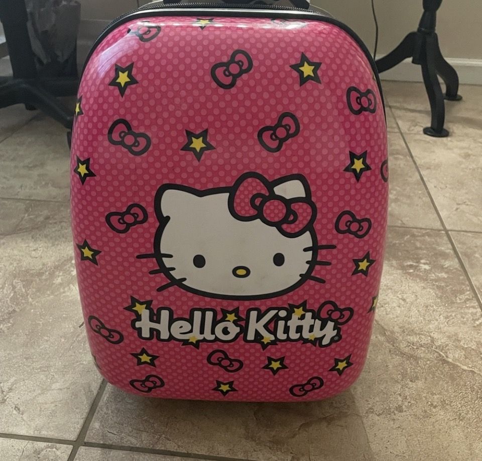 Cute vintage Hello Kitty bag with wheels. Features Hello Kitty graphic and stars.