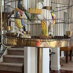 Antique brass birdcage with statues