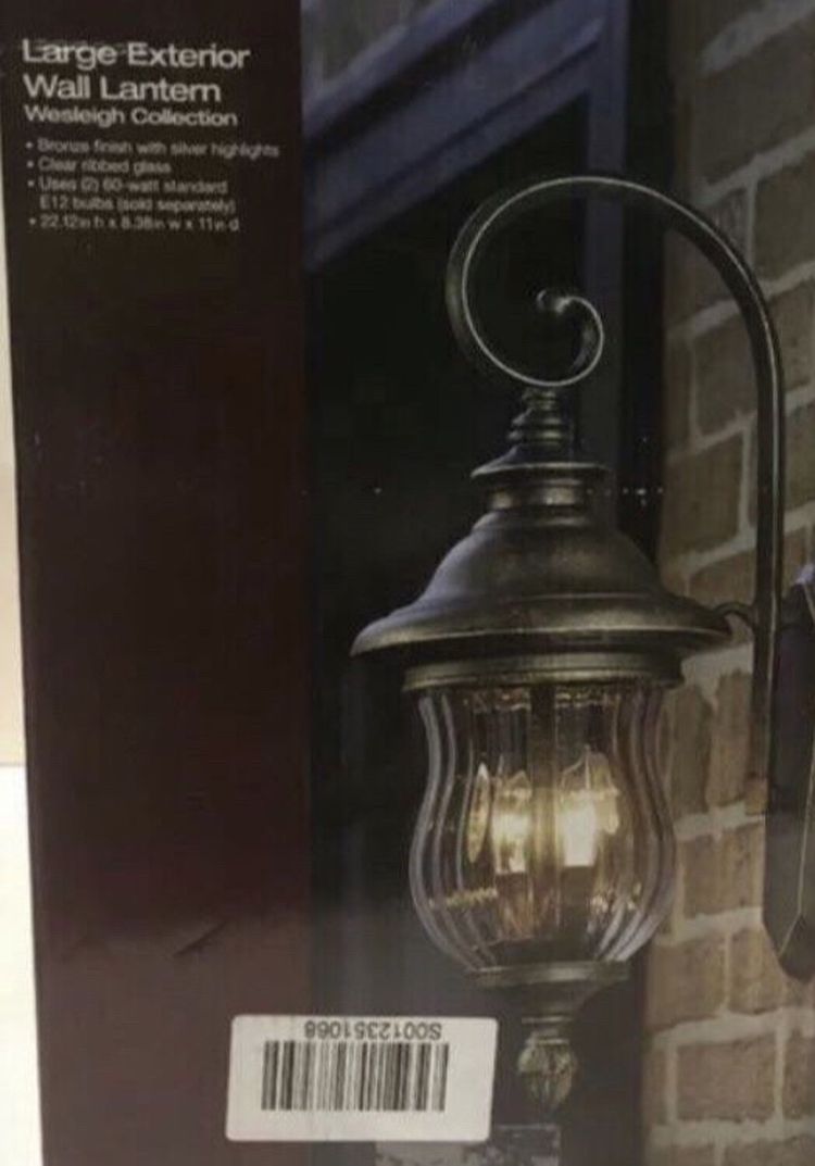 The vintage appeal of aged iron lends classic charm to the Brimfield Outdoor Wall Lantern from Home Decorators Collection. This weather-resistant out